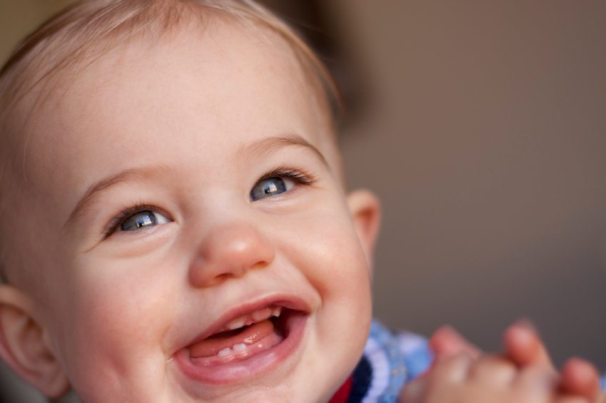 happy baby girl laughing with teeth showing